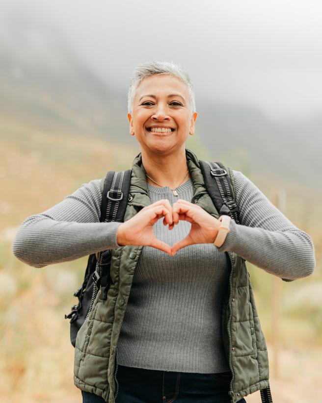 woman with hands in the shape of a heart