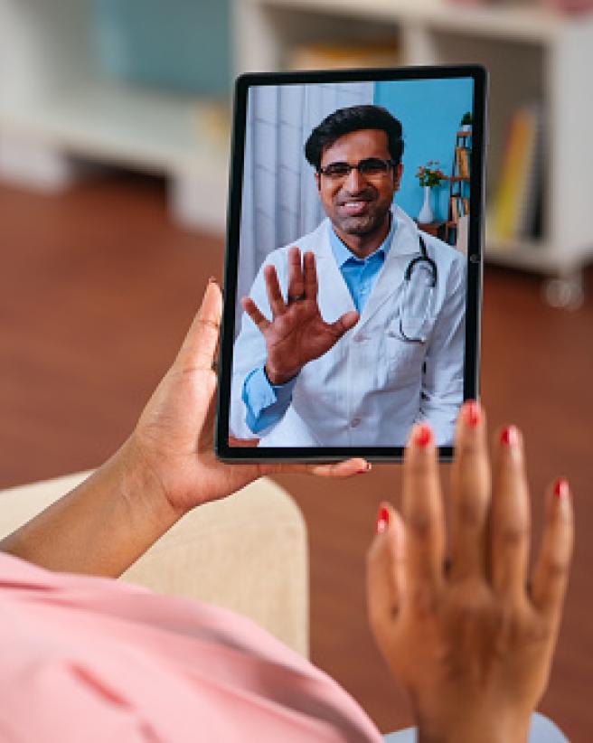 Person video chatting with a doctor on a tablet