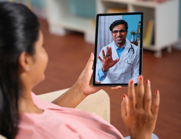 Person video chatting with a doctor on a tablet